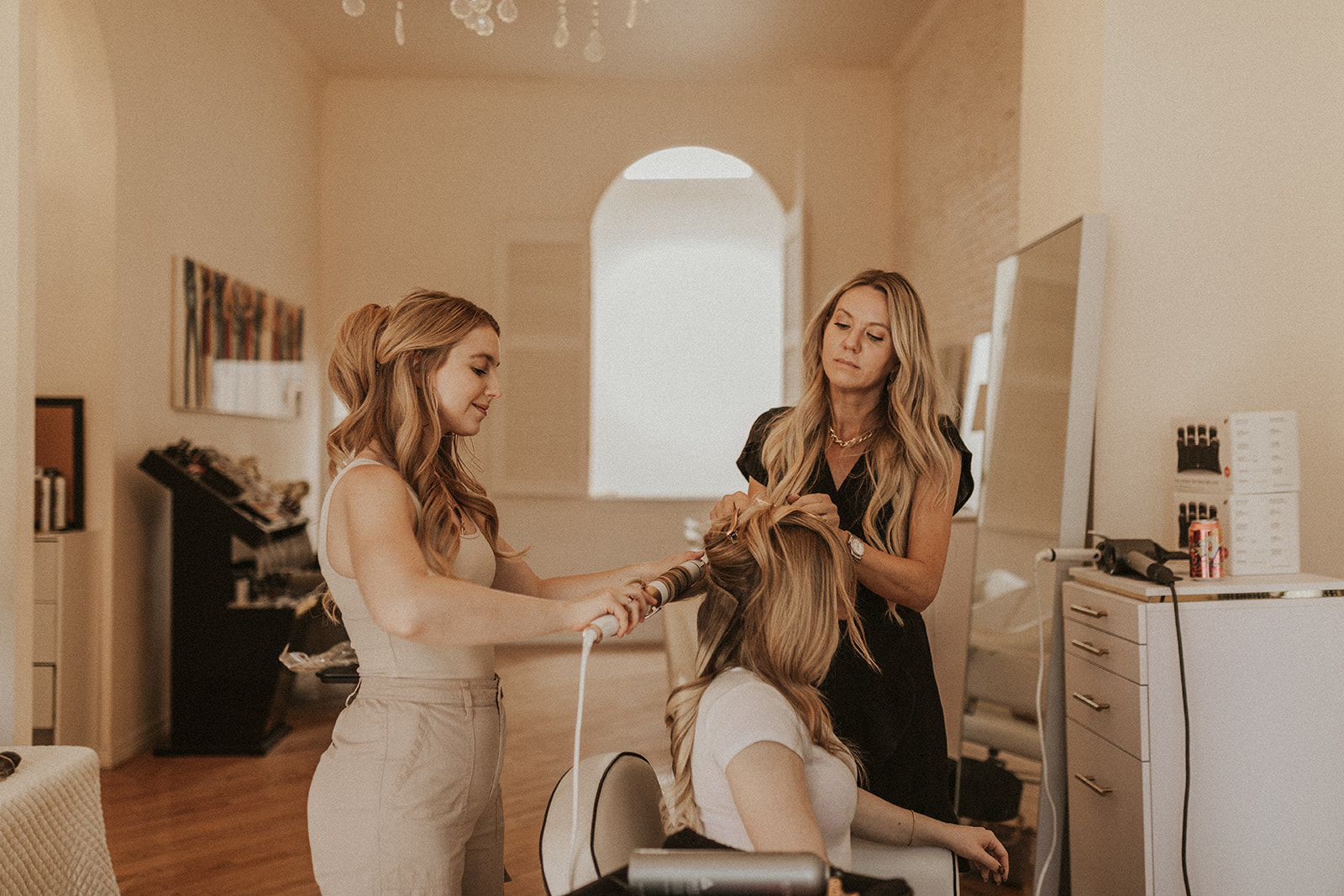 Two Fluff stylists working together during an extension appointment